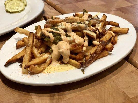 Spicy Green Chili Fries - green chili cheese sauce, roasted jalapeño, chipotle sauce, corona cheese, and chives