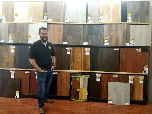 David A. standing next to one of Flooring HQ's laminate flooring displays.