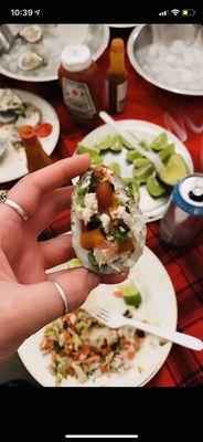 Chilled oyster topped with ceviche, lime, ketchup, salt, tapatio and SALSA NEGRA!!