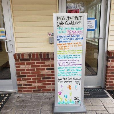 Pass-Your-Pet Care Guidelines sign with instructions to first call the office before approaching the door.