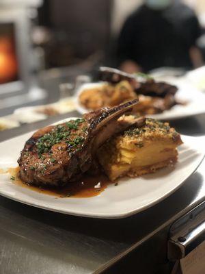 Pork Chop served with candied ginger apples, soy BBQ sauce & au gratin potatoes.