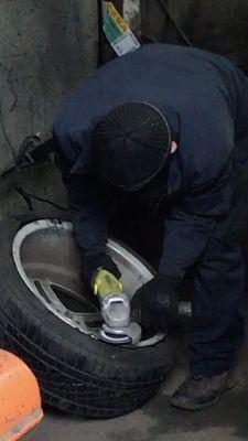 Photo of employee finally smoothing the bumpy welding job done on the rim that was causing the noise and friction!