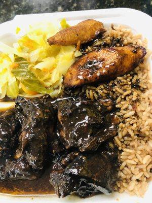 Brown stew chicken with cabbage, rice n peas. And plantains.