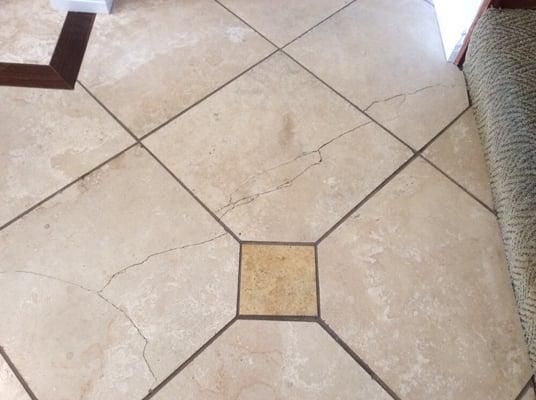 Travertine stone floor with cracks needing repair