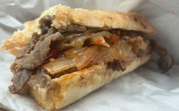 Messy yummy Cheese Steak with grilled onions