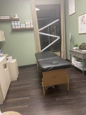 Treatment room. Sink and supplies to the left. Mini fridge with some snacks to the right. Cutely decorated and organized!