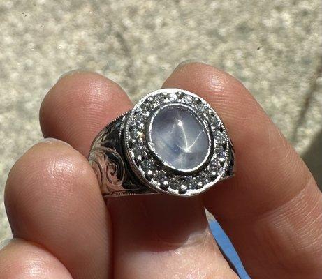 Star sapphire set in platinum ringed with diamonds