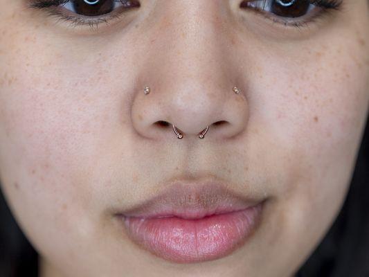 Healed nostril piercing and healed septum piercing. All Rose Gold Body Jewelry