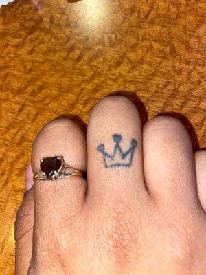 Crown finger tattoo