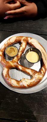 Big pretzel with spicy mustard and cheese