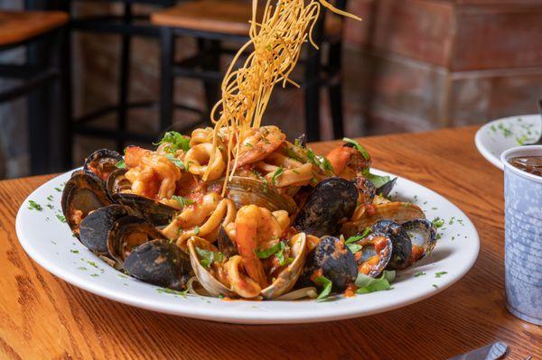 Zuppa di Pesce, clams, mussels, shrimp & calamari prepared fra diavolo, marinara or bianco style