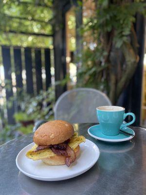 Egg Sandwich: scrambled eggs, bacon, chive, aged cheddar, chili aioli, brioche bun