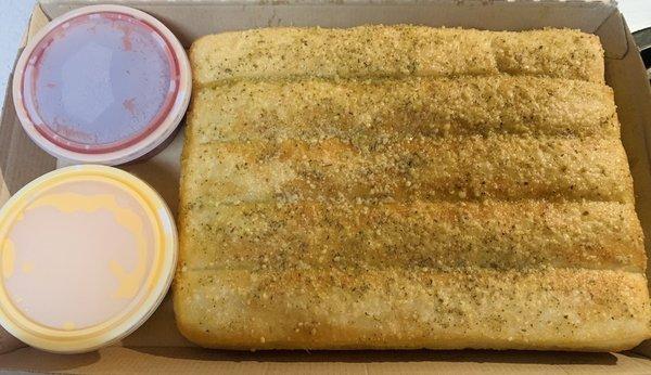 Breadsticks with cheese and marinara.