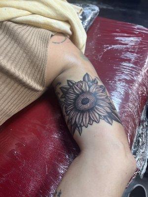 Sunflower tattoo on the arm.