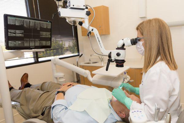 Dr. Farahmand uses the microscope for treatment of receded root surfaces.