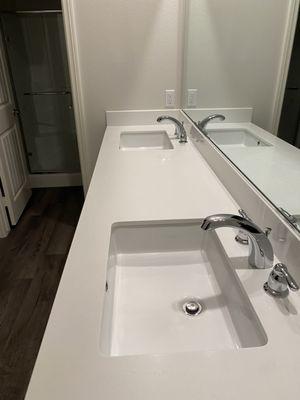 Clean double sinks  and mirror in master bedroom for move-in/move-out residential client