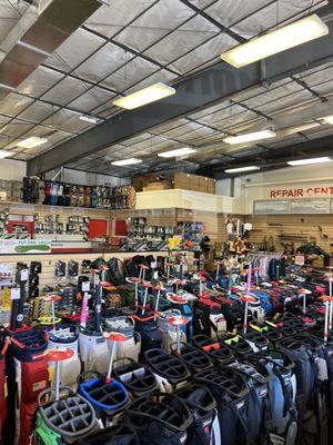 Large Selection of golf bags, repair center, putting green to the left