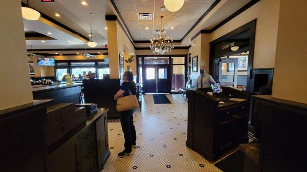 The bar is on the left. Exit to the outdoors is straight ahead. Exit to the mall is to the right. Behind me, is one of 3 dining rooms.