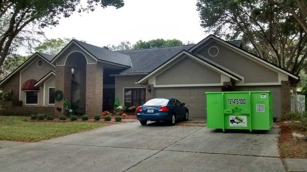 Home clean out dumpster rental.  Plenty of room to park in the driveway.  Nice, clean, green dumpster