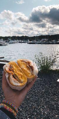 sausage, egg, and cheese on a crossiant, eggs over medium with salt pepper and hot sauce