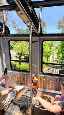 Inside the railway car, as we go up, sitting in the front