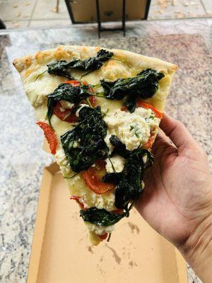 Delicious pizza slice with spinach, tomatoes, and ricotta cheese @ Mamma Lucia