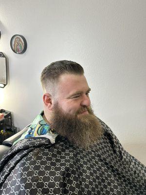 Zero mid fade slick back with beard trim.