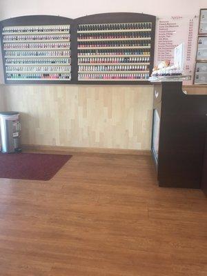 Nail polish colors by the entrance and prices on the right side.