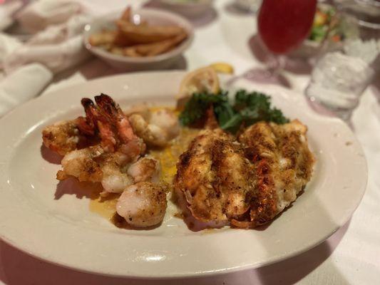 Baby Lobster Tails , Shrimp & Sea Scallops in a scampi like butter sauce  Fries in the back