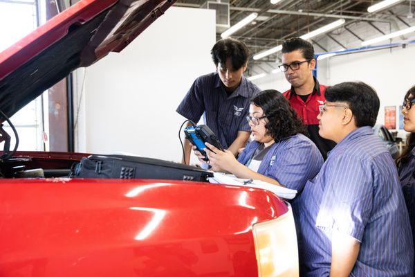 Auto Technician students working in lab.