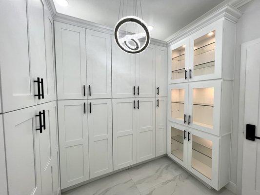 Custom built wall in closet space with glass doors that are perfect to show case handbags, perfume collections, or antiques.