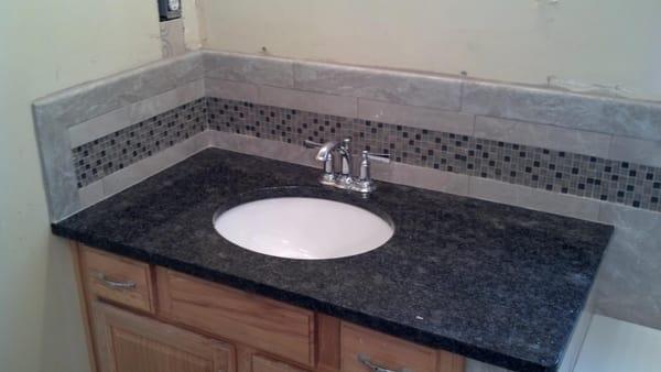 Bathroom back splash Piertra Pearl tile
 Artic Blend 5/8 x 5/8 glass
 Quartz lock 2 grout Silver gray