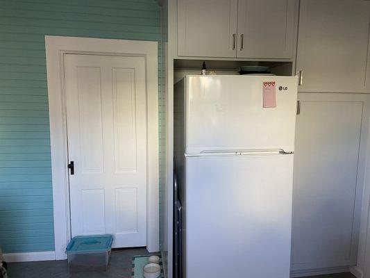 We kept a little of the old kitchen by retaining the wooden wall and updated it as a pop of color.