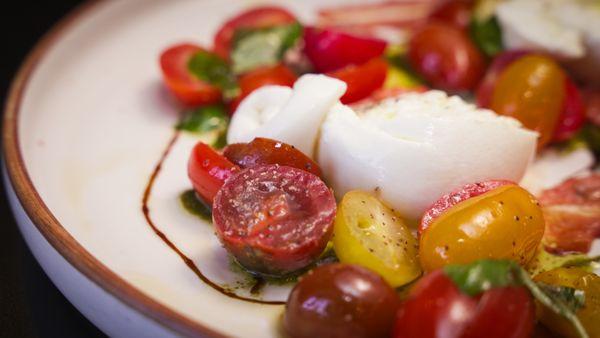 Heirloom tomatoes burrata, cheese, hazelnut romesco, sage vinaigrette served with focaccia