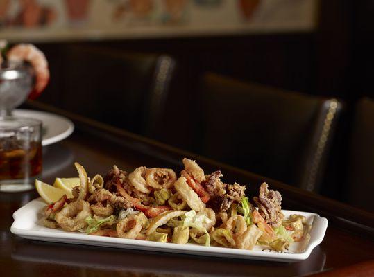 The Palm's Crispy Calamari Fritti, cornmeal-dusted with pickled lemon, peppers and marinara sauce