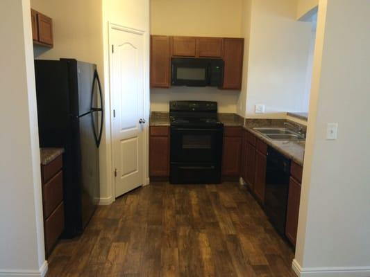 Older units have standard black appliances and no backsplash.