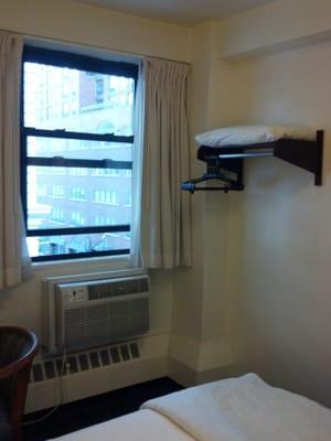 #1504 has small space for hanging items, extra pillow, 6 power outlets, overhead light, two lamps & good lighting over sink