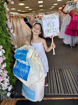 Daughter holding her newly purchased dress