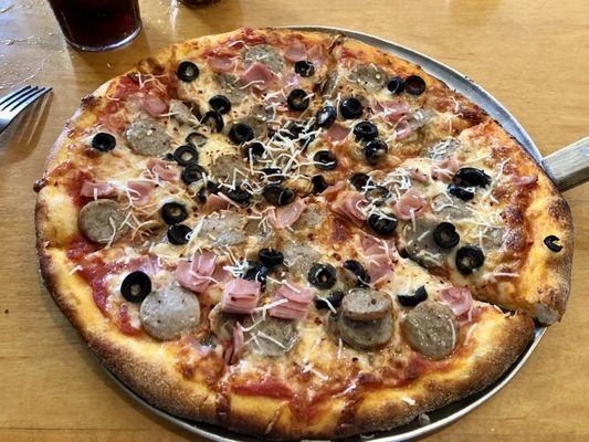 Sausage, ham, olive pizza