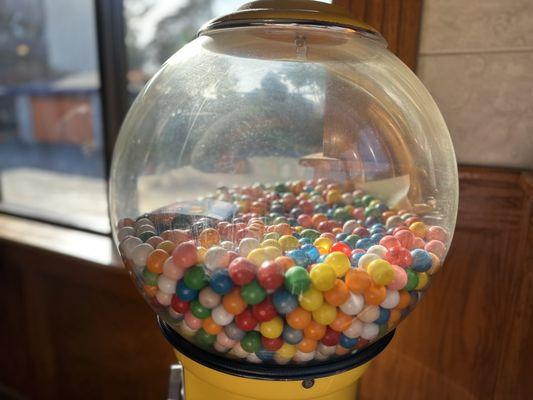 Inexplicable gum ball machine in corner