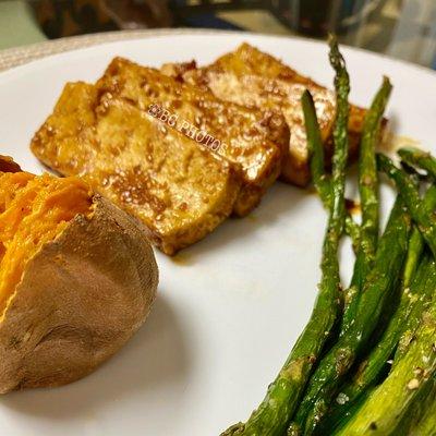 Home cooked glazed tofu with roasted asparagus and baked sweet potato prepared lovingly by hubby. Whole food & vegan dinner.