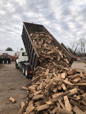 5 cords of clean kiln-dried firewood being offloaded.