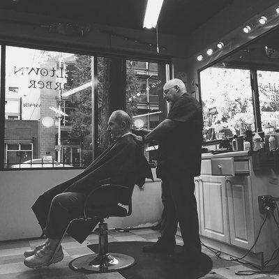 Dave, the barber, trimming a client.