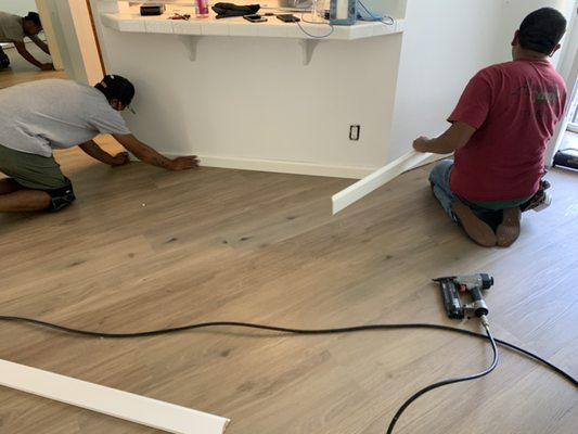 Measuring and installing the baseboards.