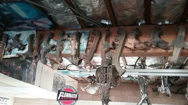 Exhaust manifold collection hanging on rafters.