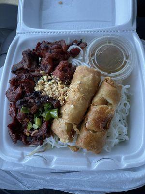 Vermicello pork salad bowl with two egg rolls to top