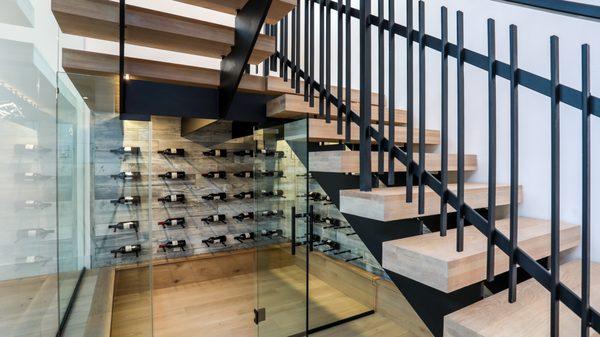 Your very own wine room under the beautiful staircase.