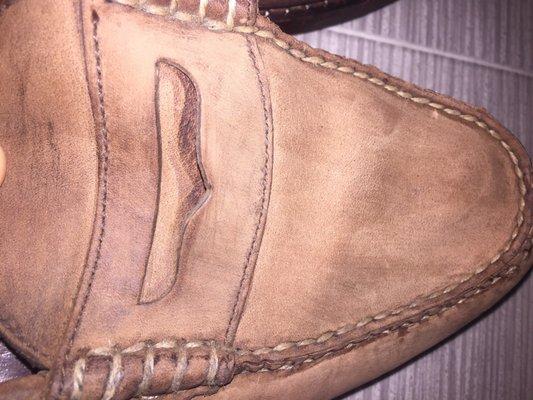 Ruined. The scraped, lighter color I received the shoe back- you can see the original darker color under the "penny holder"