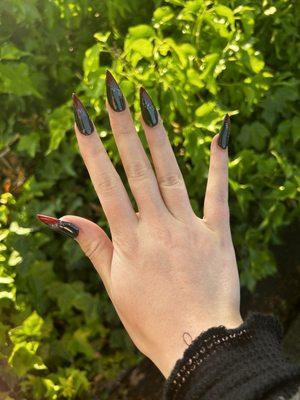 Black nails with red sparkle design