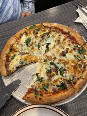 Italian pizza made with ricotta, spinach and sausage